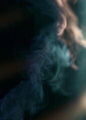 Fototapeta premium Close-up of a cloud of smoke. the smoke is dark blue in color and appears to be billowing upwards. the background is blurred, making the smoke the focal point of the image.