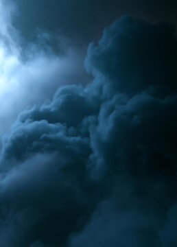 Close-up of a cloudy sky. the sky is dark and stormy, with dark clouds covering most of the frame. the clouds are white and fluffy, and they appear to be floating in the air.