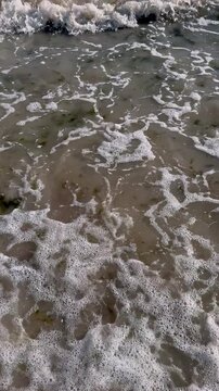 White sea foam and clear ocean water washing over sandy shore. Ideal for Reels, TikTok, and Shorts on sea relaxation, ASMR water sounds, nature backgrounds, and summer vibes.