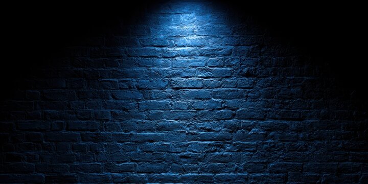 Dark brick wall illuminated by a single blue spotlight