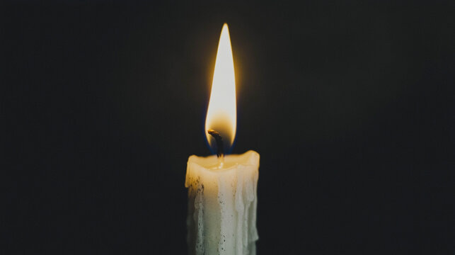 Single Lit White Candle Flame Against Dark Background