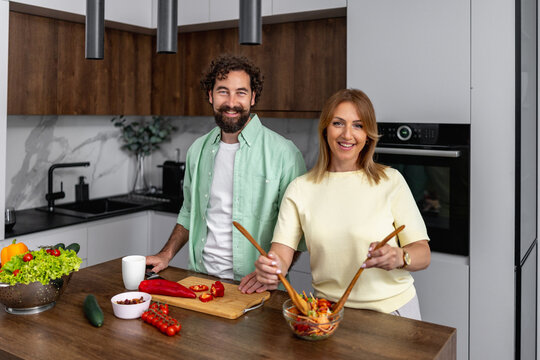 Cooking together in a modern kitchen with fresh ingredients and bright lighting