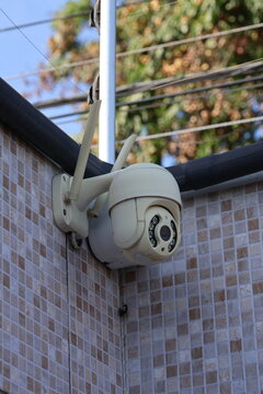 Outdoor Security Camera with Antennas Mounted on a Tiled Wall