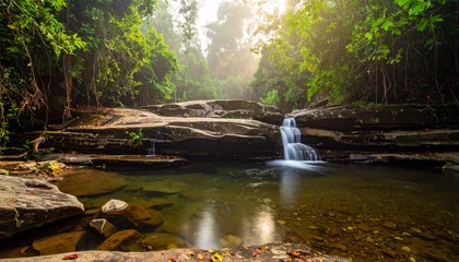 Fototapete Badezimmer Small waterfall in a lush tropical forest. Scenic jungle stream flowing over rocky terrain.  © Zeeshan