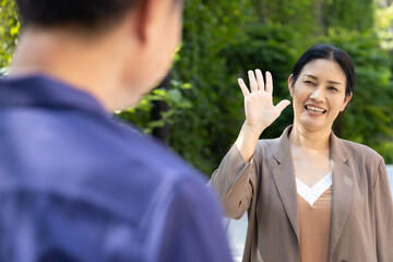 Happy laughing lovely Asian senior couple, elderly wife says hello to her old aged husband outdoor scene © 9nong