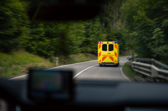 Motion blur of emergency medical service ambulance vehicle speeding on road. Emergency response mission and urgent healthcare transport concept.