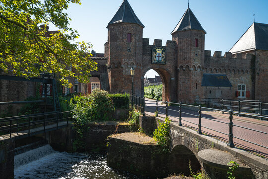 Front view of Koppelpoort gate beside a canal weir in Amersfoort
