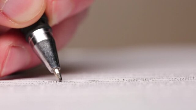 An office worker at a bank fills out documents with a pen, macro, writing with a pen