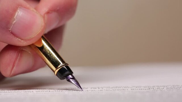 Banker fills out documents with a beautiful pen, close-up