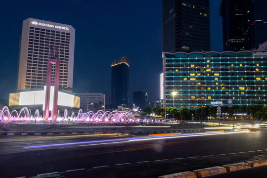 Selamat Datang Monument stands illuminated at twilight in Jakarta