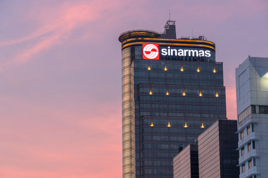 The Sinarmas Building rises above Jakarta's skyline at twilight