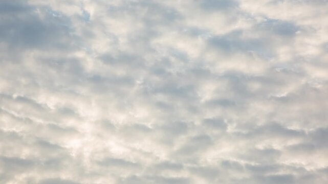 A beautiful timelapse of white clouds moving rapidly across the sky on a sunny day over a river in spring
