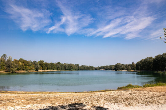Serene lake with sandy shore and trees, Germany, Bavaria, Augsburg Kuhsee, 2 August 2026