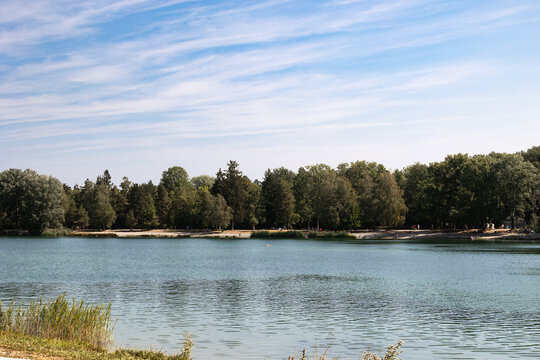 Calm lake with surrounding forest and sandy beach, Germany, Bavaria, Kuhsee, 2 August 2026