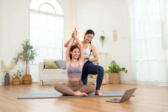 Friends Practice Yoga Together in a Bright Room