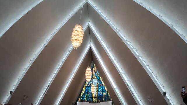 Low angle interior view of Arctic Cathedral ceiling and chandeliers in Tromso Norway