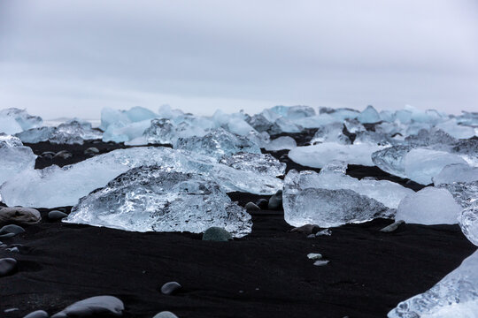 Glacial ice blocks on black sand at Jokulsarlon Diamond Beach, Iceland