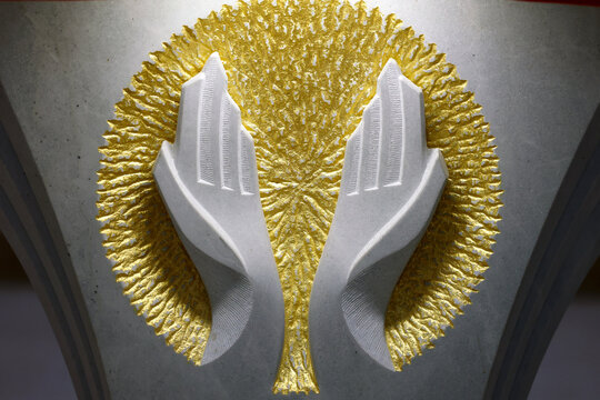 Sculpture of two hands open in prayer. A symbol of the Lord's Prayer.