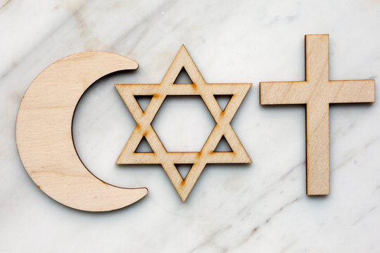 Interfaith symbols: the Christian cross, the Jewish Star of David, and the Islamic crescent, representing faith and harmony.