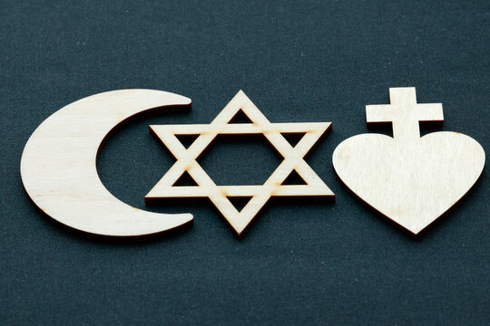 Three major religious symbols: the crescent of Islam, the Star of David of Judaism, and the heart surmounted by a cross of Christianity. This composition illustrates interfaith dialogue.