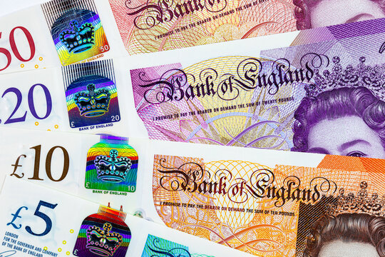 British currency, featuring various Great Britain Pound (GBP) banknotes including 5, 10, 20 and 50 pound notes with Queen Elizabeth II portrait. Money of Europe.