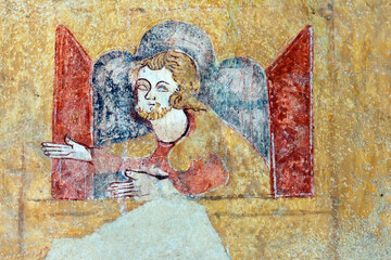Detail of a religious mural adorning the chapel in Moutiers. Noah appears at the window of the Ark, his arms outstretched between two red shutters, 12th–13th century. Moutiers, France. © Godong Photo