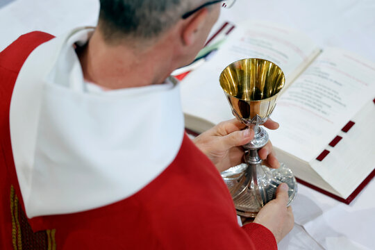 A priest celebrates Mass at the Sanctuary of the Blessed Fountain, holding a golden chalice. Eucharistic celebration.