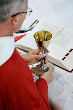 A priest celebrates Mass at the Sanctuary of the Blessed Fountain, holding a golden chalice. Eucharistic celebration.