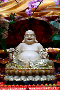 Xa Loi Pagoda. A statuette of Budai&mdash;with his beaming smile, protruding belly, and rosary&mdash;characterizes this legendary figure identified with the future Maitreya. Ho Chi Minh City, Vietnam.