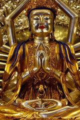Fototapeta premium Vietnam Quoc Tu Pagoda. Guanyin, or Quan Am, the bodhisattva of universal compassion with a thousand arms. Her main hands are joined in the anjali mudra. Ho Chi Minh City, Vietnam.