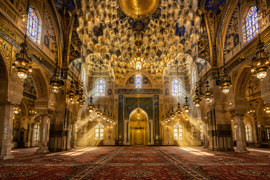Mosque interior with geometric patterns and light shafts, Islamic architecture