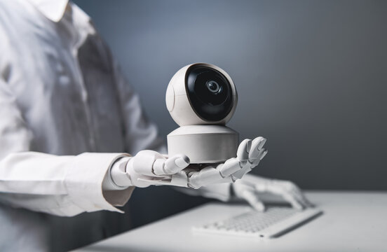 Robotic Hand Showing CCTV Security Camera with Computer Keyboard Background for AI Security