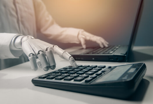 Close-up Robot Hand Pressing Calculator Buttons with Laptop for AI Finance Concept