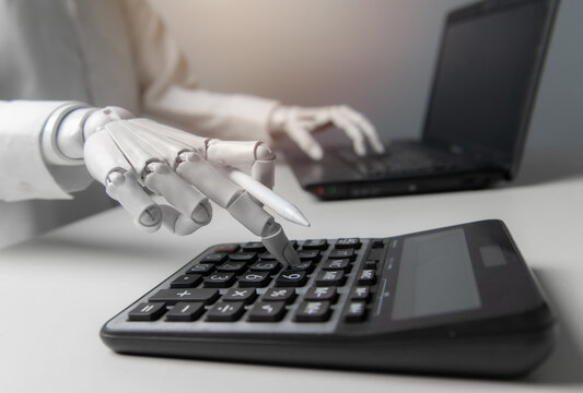 Close-up Robot Hand Pressing Calculator Buttons with Laptop for AI Finance Concept