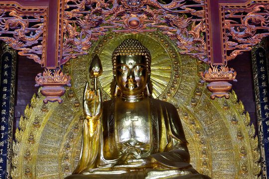 Bai Dinh Pagoda. A giant gilded statue of Shakyamuni Buddha in meditation, holding a lotus flower&mdash;a symbol of purity and enlightenment. Ninh Binh, Vietnam.