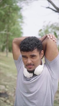Athlete stretching his arms outdoors before running