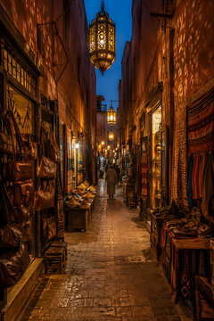 Marrakech medina alley at night with Moroccan lanterns, authentic travel photo