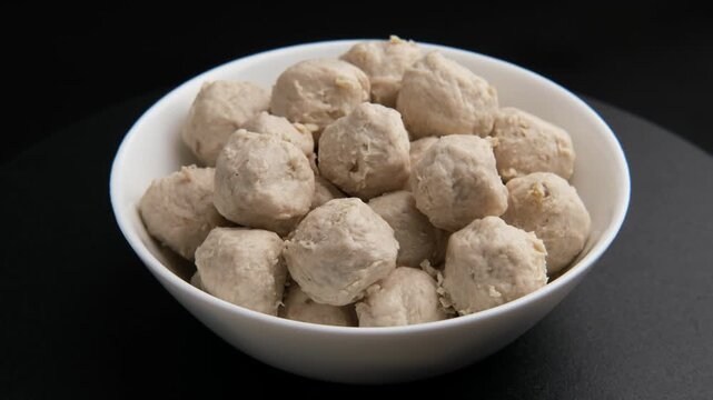 Pork tendon meatballs in white bowl.(Thai Pork Tendon Balls)	