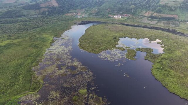 Aerial Drone View of Danau Mas Lake Surrounded by Tropical Forest in Indonesia, 4K