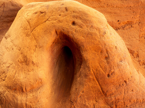 a strange fissure in the shape of an oblong hole in the ochre soil of Roussillon, France