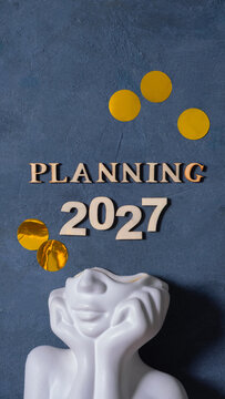 Planning for the year 2027 with decorative elements on dark background