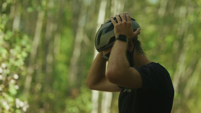 Cyclist Putting On Protective Helmet In Forest Before Riding.  Sports Equipment Safety Preparation. Biking Workout 