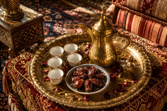Arabic coffee dallah pot with dates and cups, traditional Middle East hospitality