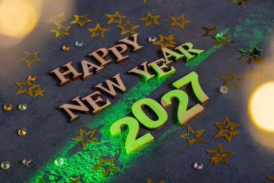 Happy New Year wishes for 2027 with colorful decorations and stars on a dark background
