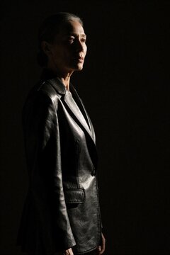 Chiaroscuro Portrait of Mature Woman in Leather Jacket Profile with Dramatic Lighting