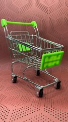 Close-up view of a miniature metal shopping cart with bright green accents against a textured backdrop © MR HEPPY