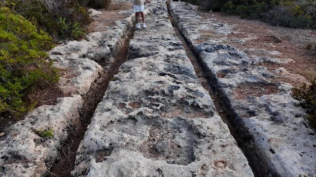 Ancient Cart Ruts on Xemxija heritage trail, parallel cartways groves cut into bare rock.
