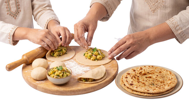 Traditional Indian Aloo Paratha preparation, hands stuffing flatbread with potato filling, authentic homemade South Asian cuisine cooking process isolated PNG with Transparent Background
