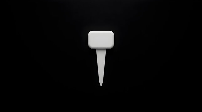 Single White Golf Tee Standing Upright Against a Stark Black Background in a Studio Setting Detailed Macro Shot