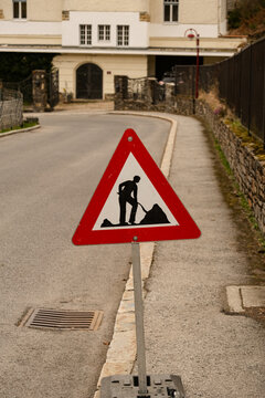 RRoad work warning sign placed on a quiet residential street, 